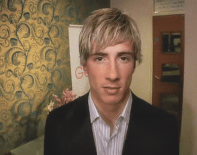 A Man In A Suit Stands In Front Of A Wall With A Google Sign GIF