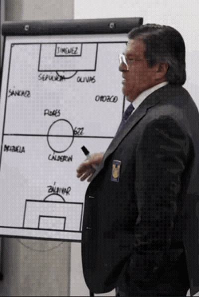 A Man In A Suit Stands In Front Of A White Board That Says ' Timenez ' On It GIF