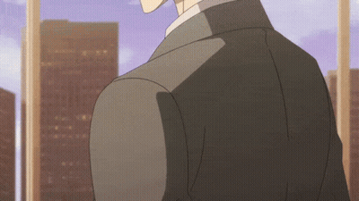 A Man In A Suit Stands In Front Of A Window With A City In The Background GIF