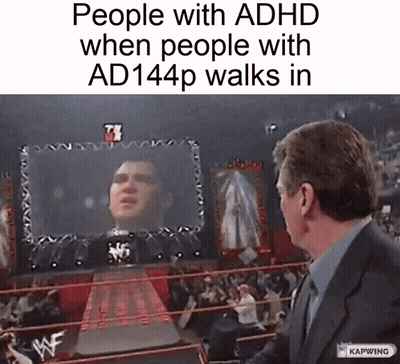 A Man In A Suit Stands In Front Of A Wrestling Ring With A Screen Behind Him That Says People With Adhd GIF
