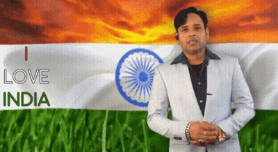 A Man In A Suit Stands In Front Of An Indian Flag And Says I Love India GIF