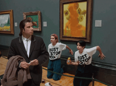 A Man In A Suit Stands In Front Of Two Girls Wearing Just Stop Oil T-Shirts GIF
