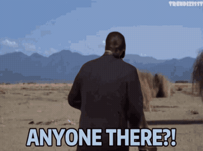 A Man In A Suit Stands In The Desert And Says Anyone There GIF