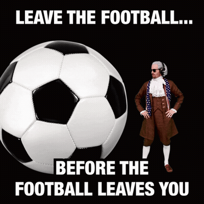 A Man In A Suit Stands Next To A Soccer Ball With The Words " Leave The Football Before The Football Leaves You " GIF