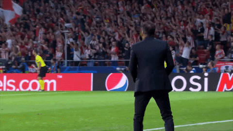 A Man In A Suit Stands On A Soccer Field In Front Of An Advertisement For Pepsi GIF