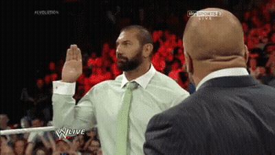 A Man In A Suit Takes A Oath In Front Of A Crowd On A Wrestling Show GIF