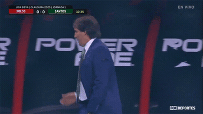 A Man In A Suit Talks On A Cell Phone In Front Of A Power Ad Sign GIF