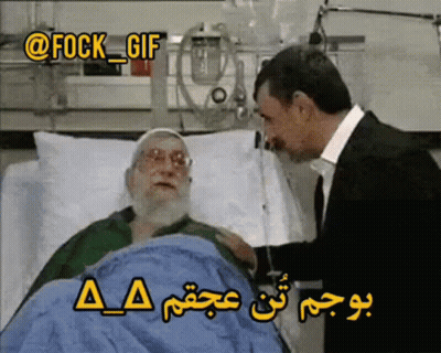A Man In A Suit Talks To An Elderly Man In A Hospital Bed GIF