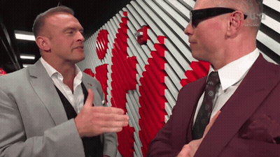 A Man In A Suit Talks To Another Man In A Suit GIF