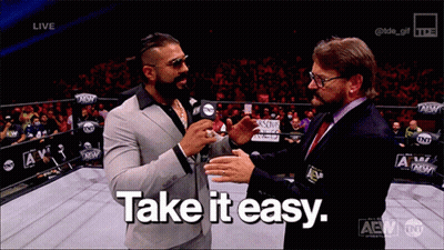 A Man In A Suit Talks To Another Man With The Words Take It Easy GIF