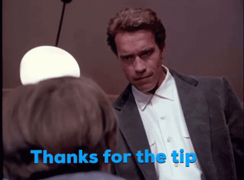 A Man In A Suit Talks To Another Man With The Words Thanks For The Tip Behind Him GIF