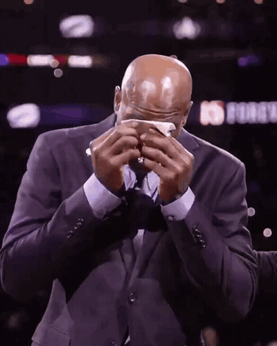A Man In A Suit Wipes His Face With A Napkin In Front Of A Sign That Says ' Nba Force ' GIF