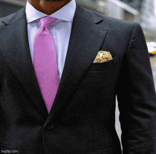 A Man In A Suit With A Pink Tie And Pocket Square GIF