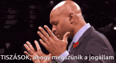 A Man In A Suit With A Poppy On His Lapel Holds His Hands Together In Prayer GIF
