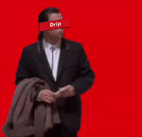 A Man In A Suit With A Red Drip Sticker On His Face GIF