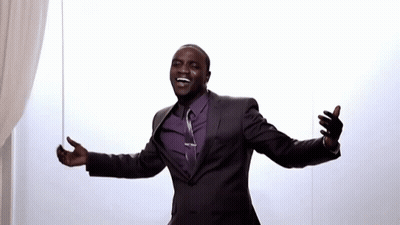 A Man In A Suit With His Arms Outstretched GIF