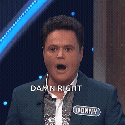 A Man In A Suit With The Name Donny On His Chest GIF