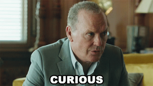 A Man In A Suit With The Word Curious Written On His Face GIF