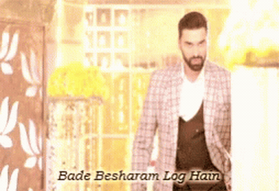 A Man In A Suit With The Words Bade Besharam Log Hain Written Above Him GIF