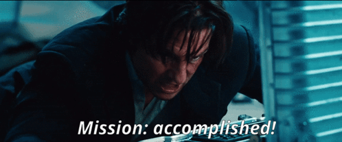 A Man In A Suit With The Words Mission Accomplished On The Bottom GIF