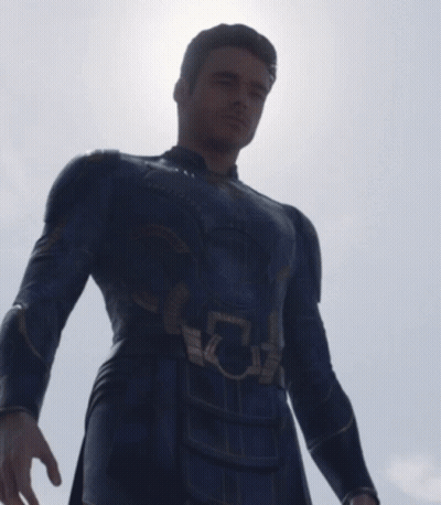 A Man In A Superhero Costume Has A Light Coming Out Of His Eye GIF