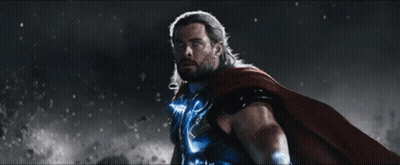 A Man In A Superhero Costume Holds A Hammer GIF