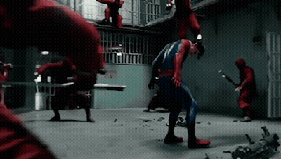A Man In A Superhero Costume Is Being Attacked By A Group Of Men In Red GIF