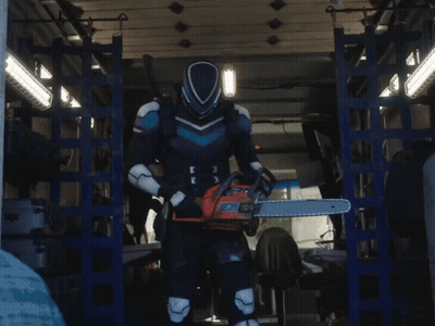 A Man In A Superhero Costume Is Holding A Chainsaw In His Hand GIF