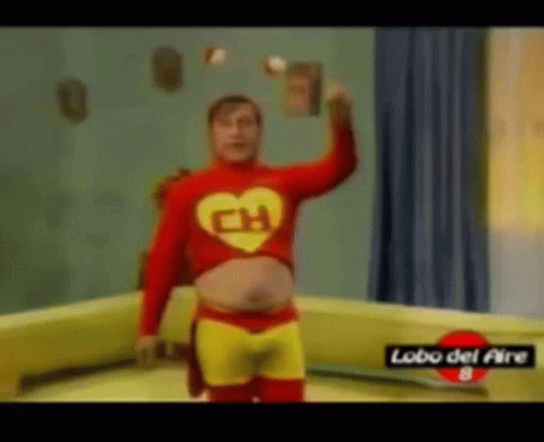 A Man In A Superhero Costume Is Juggling A Book . GIF