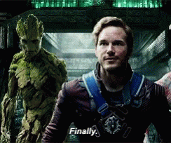 A Man In A Superhero Costume Is Standing Next To A Green Monster And Says Finally . GIF