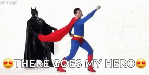 A Man In A Superhero Costume Is Standing Next To A Man In A Batman Costume . GIF