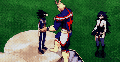 A Man In A Superhero Costume Is Standing On A Podium With Two Other People GIF