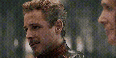 A Man In A Superhero Costume Is Talking To Another Man In A Room . GIF