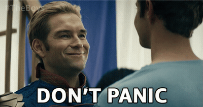 A Man In A Superhero Costume Says " Don T Panic " GIF
