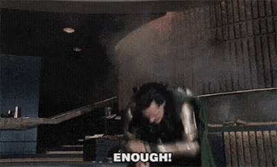 A Man In A Superhero Costume Says " Enough " In Front Of Him GIF