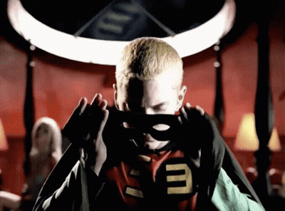 A Man In A Superhero Costume With The Letter E On His Chest GIF