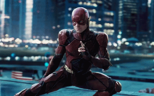 A Man In A Superhero Suit Is Holding A Sword GIF