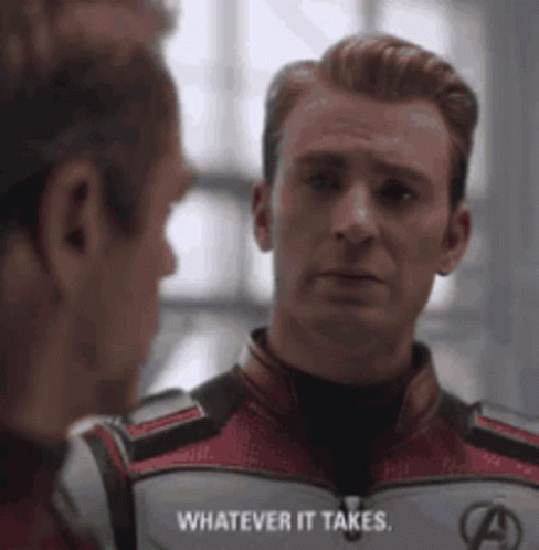 A Man In A Superhero Suit Is Talking To Another Man In A Room . GIF
