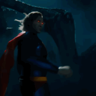 A Man In A Superman Costume Has A Red And Yellow S On His Chest GIF