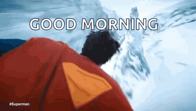 A Man In A Superman Costume Says Good Morning In Front Of A Snowy Mountain GIF