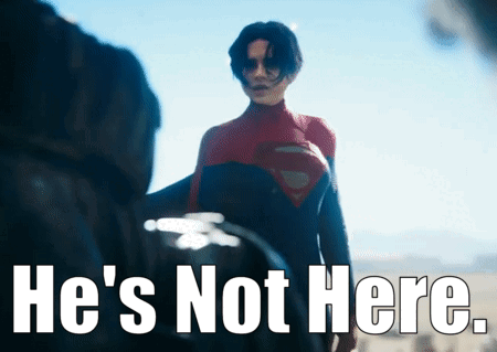 A Man In A Superman Costume Stands In Front Of A Sign That Says " He 'S Not Here " GIF