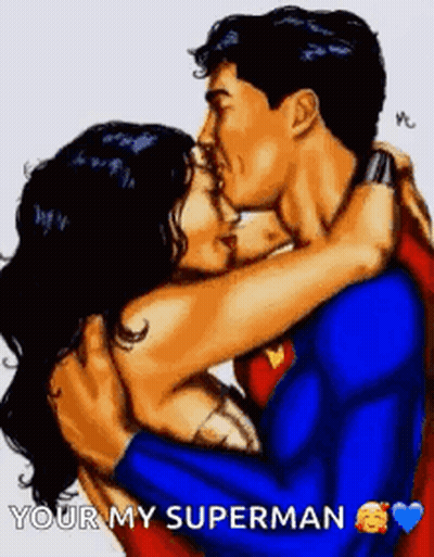 A Man In A Superman Suit Is Hugging A Woman In A Wonder Woman Costume . GIF
