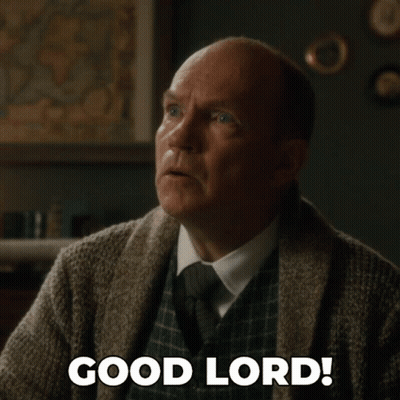A Man In A Sweater And Tie Is Saying Good Lord GIF
