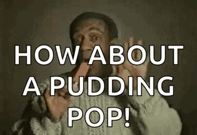 A Man In A Sweater Is Eating A Pudding Pop And Making A Funny Face . GIF