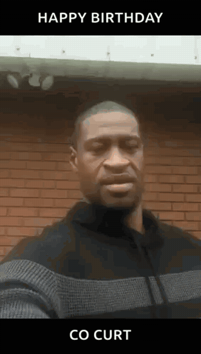 A Man In A Sweater Is Standing In Front Of A Brick Wall And Says Happy Birthday Co Curt . GIF
