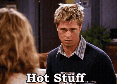 A Man In A Sweater Is Talking To A Woman And The Words Hot Stuff Are Next To Him GIF