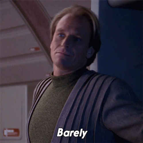 A Man In A Sweater Says Barely On The Screen GIF