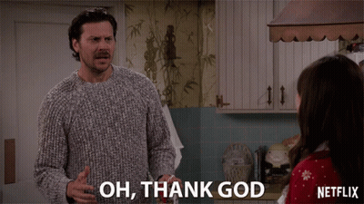 A Man In A Sweater Says " Oh Thank God " In Front Of A Woman GIF