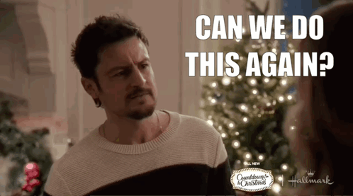 A Man In A Sweater Stands In Front Of A Christmas Tree And Says Can We Do This Again GIF