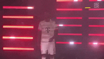 A Man In A T-Mobile Jersey Is Walking Through A Tunnel Of Lights GIF